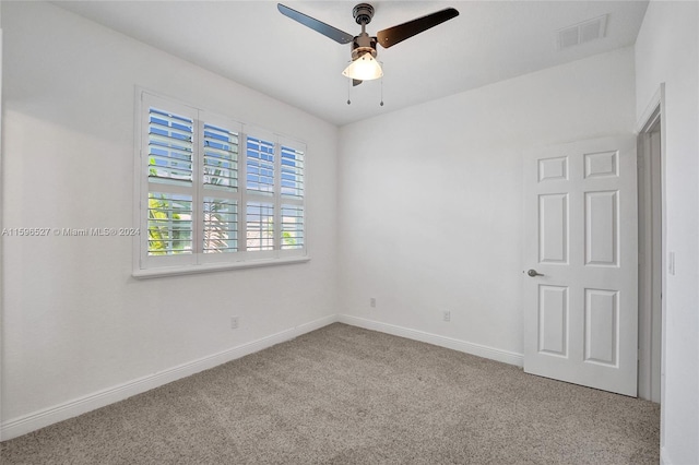 unfurnished room with ceiling fan and light colored carpet