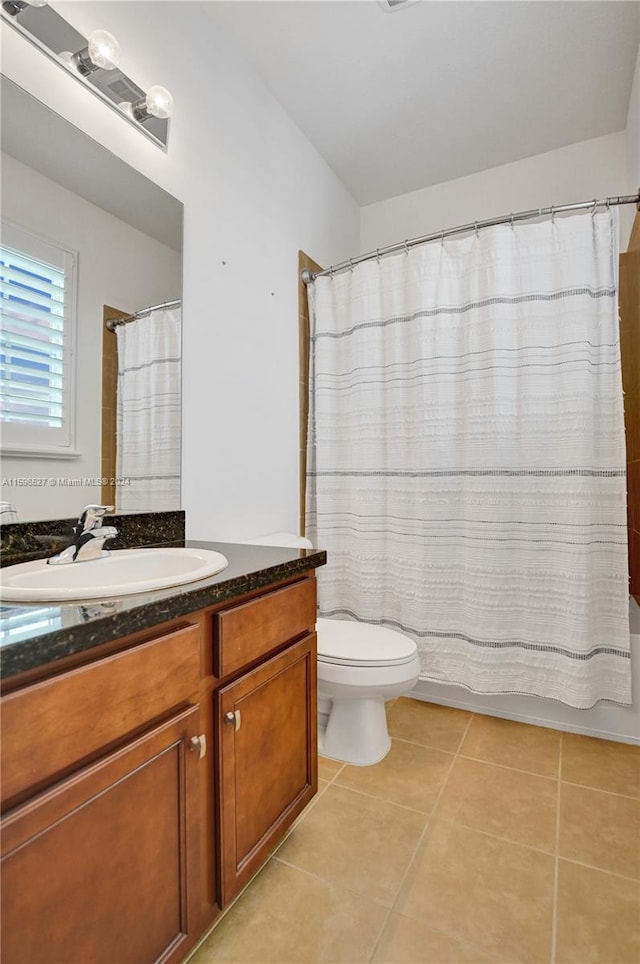 full bathroom with tile patterned flooring, vanity, toilet, and shower / bathtub combination with curtain