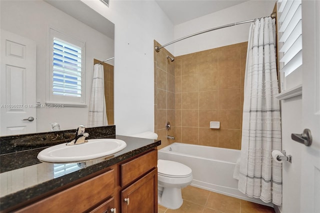 full bathroom with toilet, shower / bath combo, vanity, and tile patterned floors