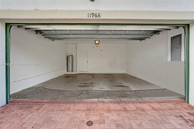 garage with electric panel and water heater