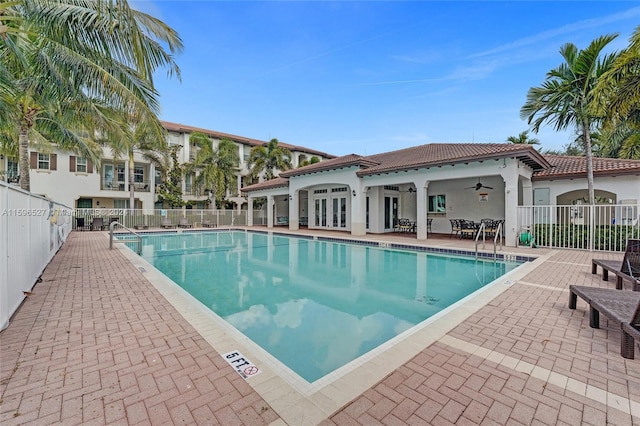 view of pool with ceiling fan and a patio