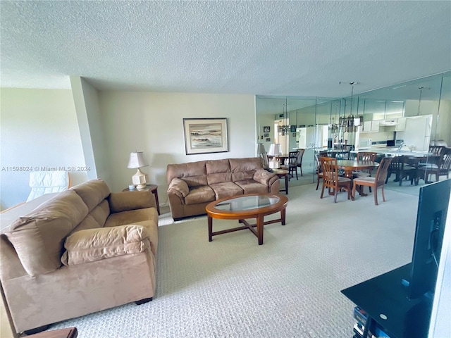 carpeted living room featuring a textured ceiling