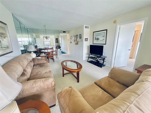 carpeted living room featuring a textured ceiling