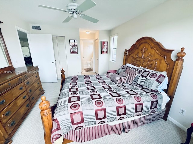 carpeted bedroom featuring connected bathroom, a closet, and ceiling fan