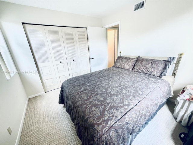 carpeted bedroom featuring a closet