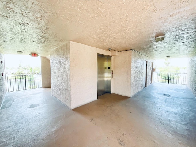 interior space featuring concrete flooring and elevator