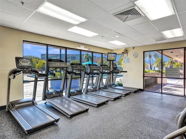 exercise room with a paneled ceiling