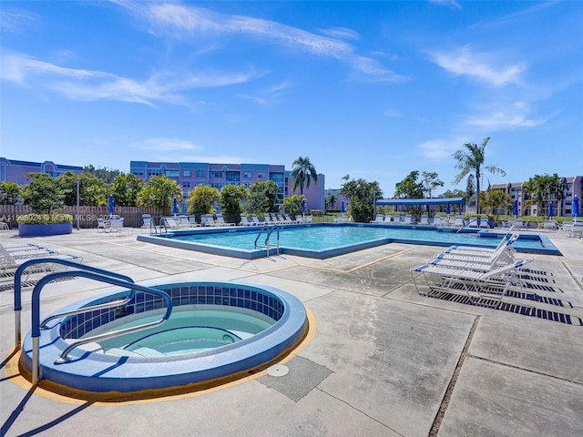 view of pool with a community hot tub and a patio