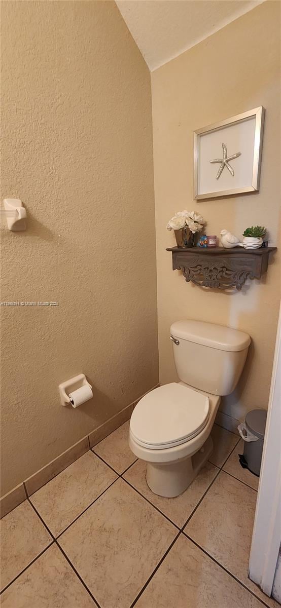 bathroom featuring tile patterned flooring and toilet