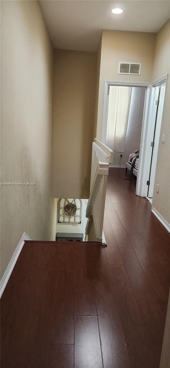 hall with dark hardwood / wood-style flooring