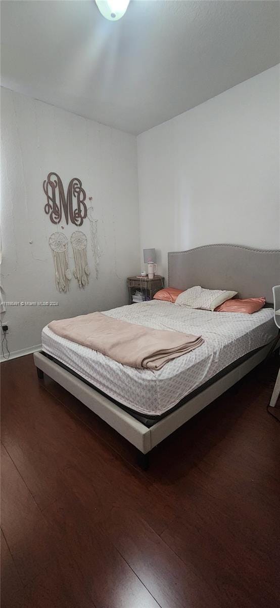 unfurnished bedroom featuring dark wood-type flooring