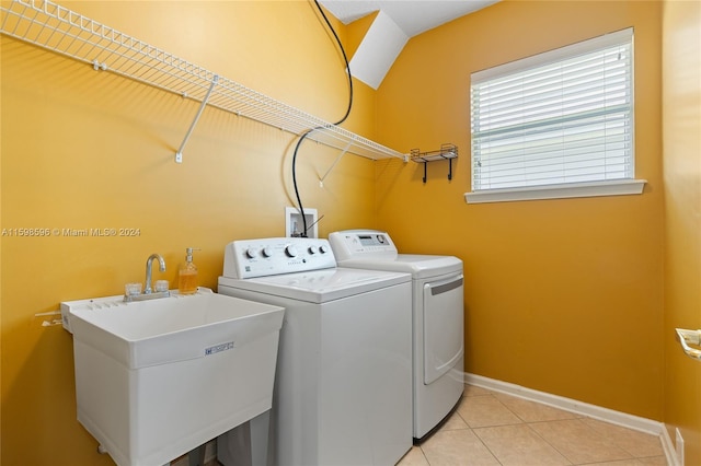 washroom featuring light tile patterned floors, independent washer and dryer, and sink