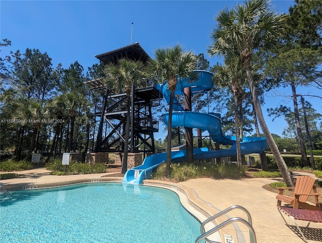 view of pool with a water slide