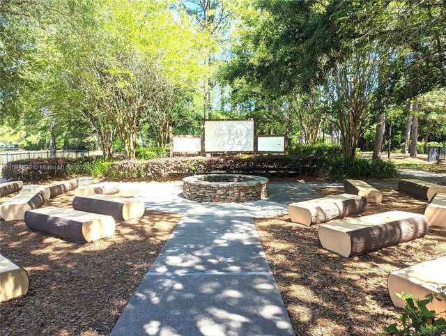 surrounding community featuring an outdoor fire pit