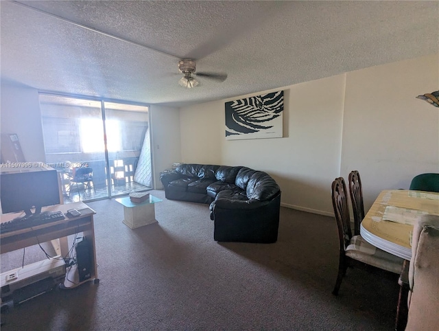 living room featuring ceiling fan and a textured ceiling