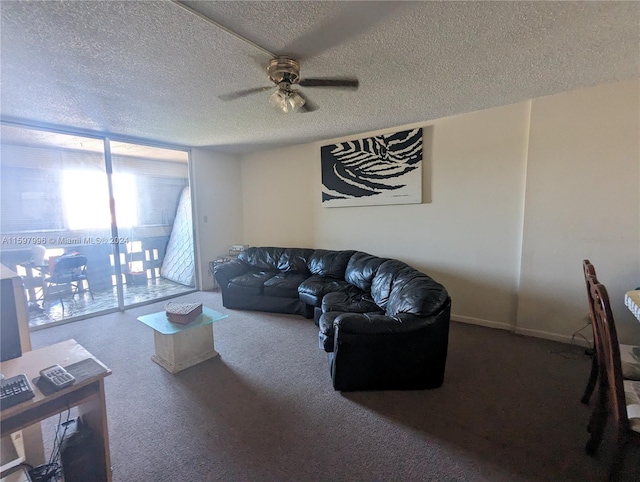 carpeted living room with ceiling fan and a textured ceiling