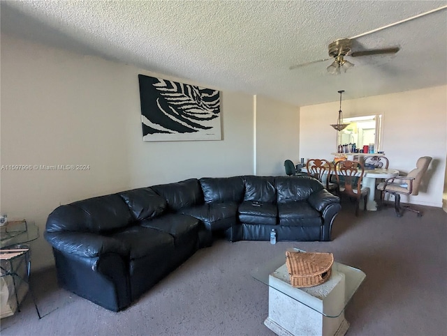 living room featuring ceiling fan and a textured ceiling