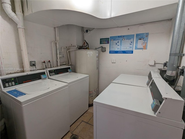 washroom featuring washing machine and dryer and water heater