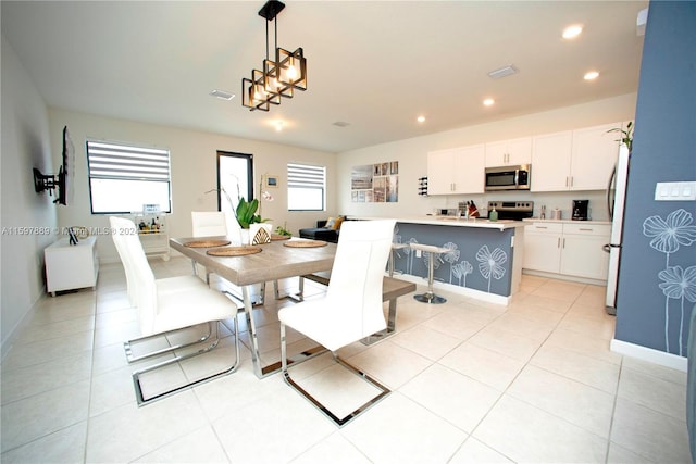 dining space featuring light tile patterned floors