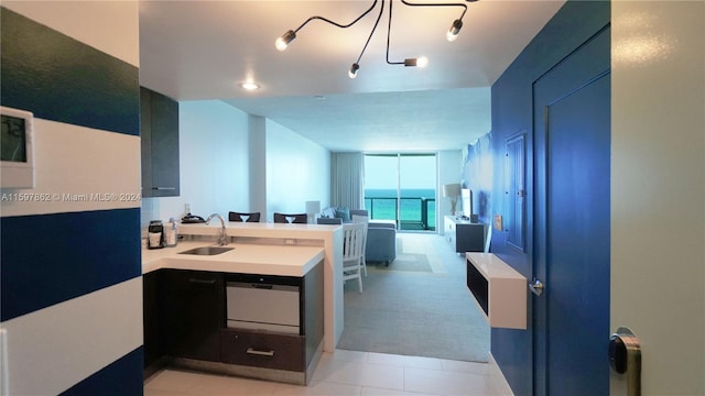 bathroom featuring track lighting, sink, tile floors, and a water view