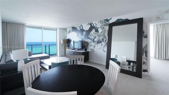 carpeted dining space featuring a water view