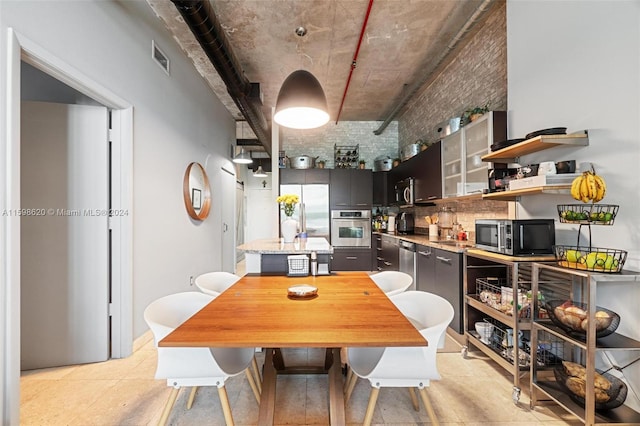 tiled dining area featuring brick wall