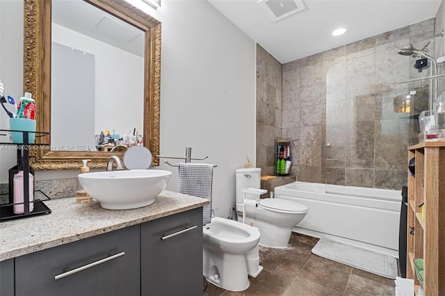 full bathroom with vanity, a bidet, tiled shower / bath combo, and toilet