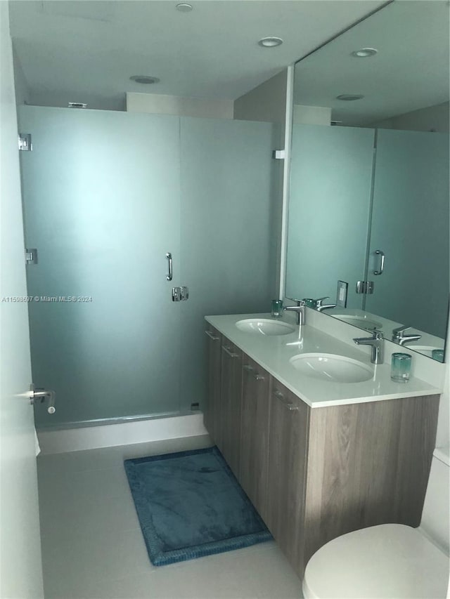 bathroom featuring tile patterned floors, vanity, and toilet