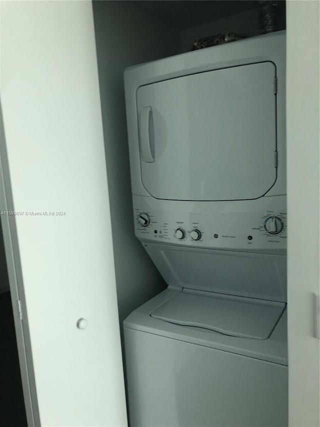 washroom with stacked washer and dryer