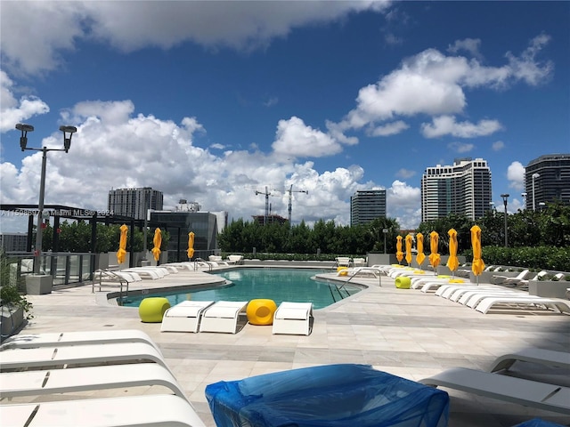 view of swimming pool with a patio and a pergola