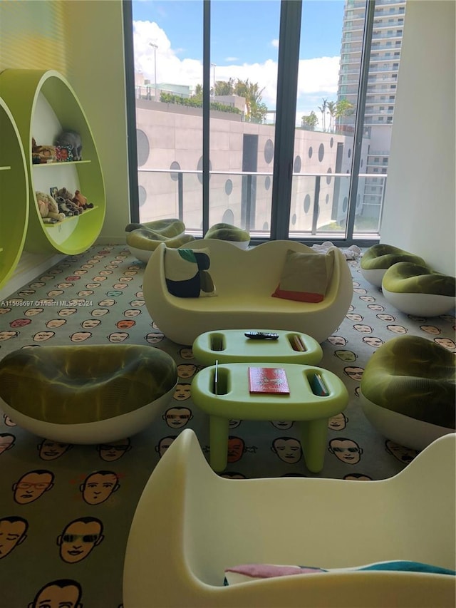 recreation room featuring plenty of natural light and carpet floors