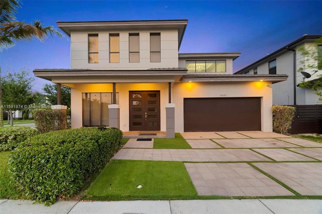 view of front facade featuring a garage and french doors