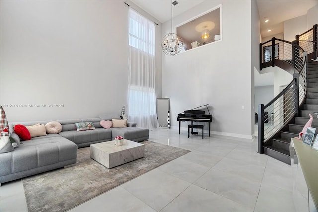 living room with a towering ceiling and a chandelier