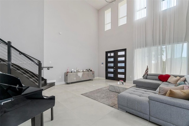 living room featuring french doors and a towering ceiling