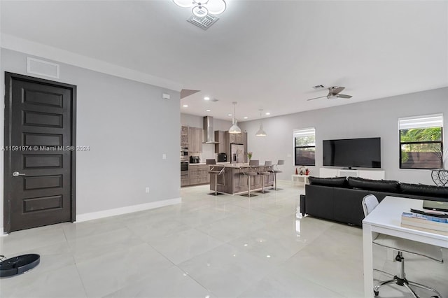 living room with ceiling fan and light tile patterned floors