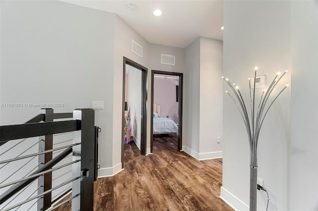 corridor with hardwood / wood-style flooring