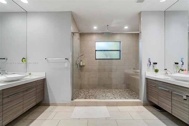 bathroom featuring vanity, tile patterned floors, and an enclosed shower