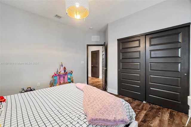 bedroom with a closet and dark hardwood / wood-style floors