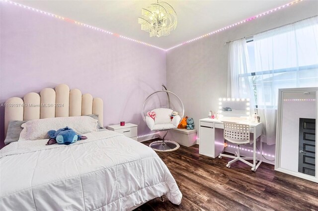 bedroom featuring dark wood-type flooring and a notable chandelier