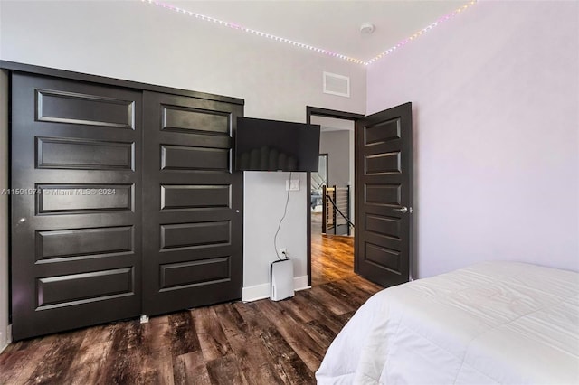 bedroom with a closet and dark wood-type flooring