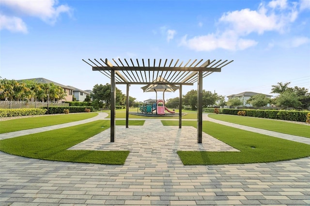 view of community with a yard, a pergola, and a playground