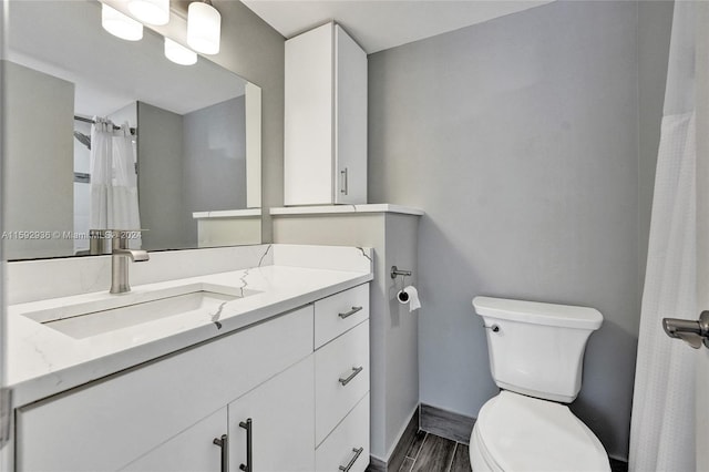 bathroom featuring vanity and toilet