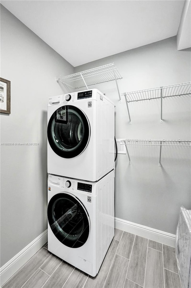 laundry room with stacked washer / dryer