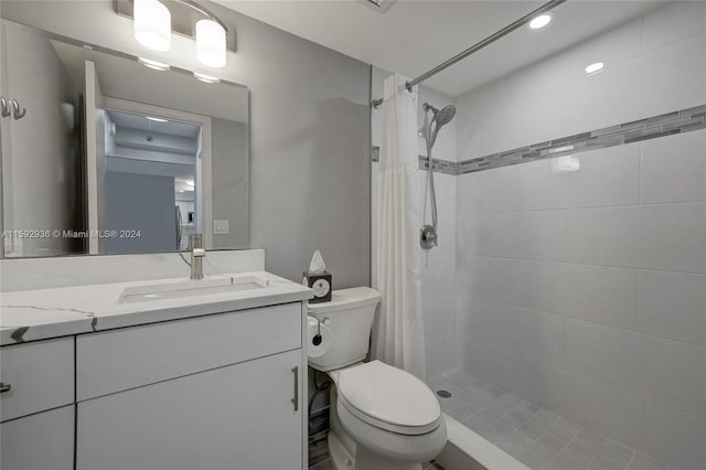 bathroom featuring vanity, curtained shower, and toilet