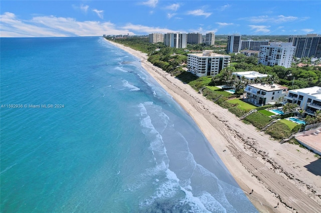 drone / aerial view with a water view and a view of the beach