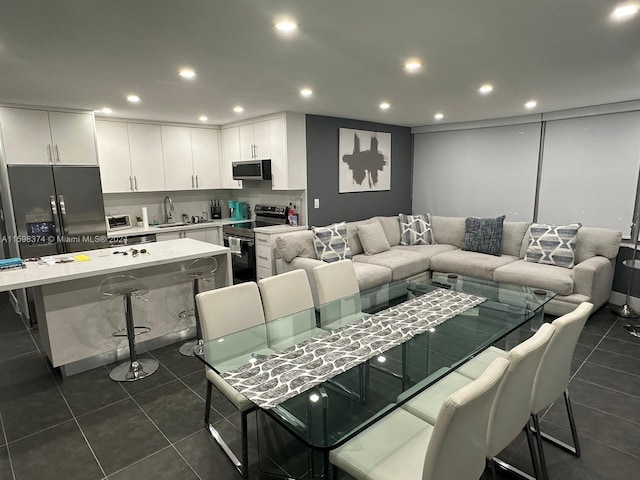 dining room with sink and dark tile flooring