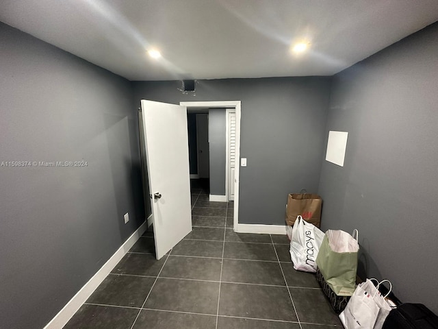 interior space with dark tile flooring