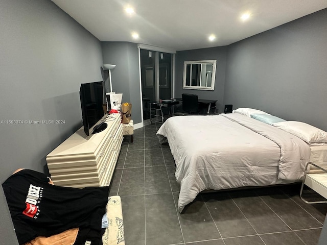 bedroom featuring dark tile floors