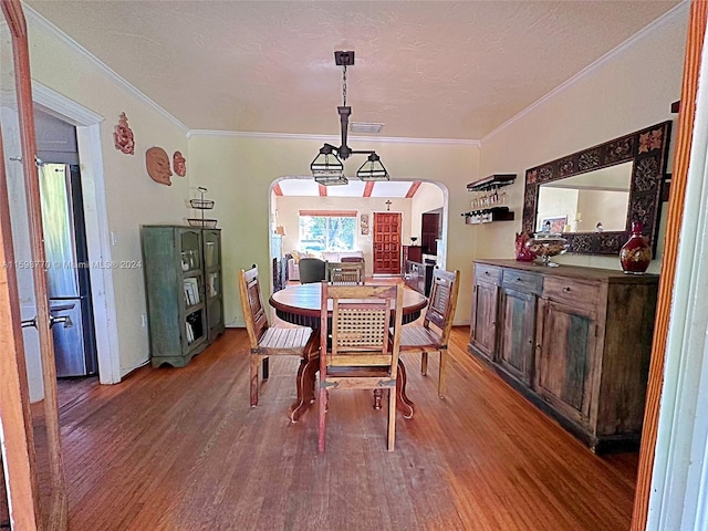 dining room featuring ornamental molding and wood-type flooring