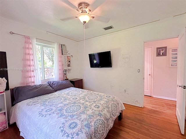 bedroom featuring hardwood / wood-style flooring and ceiling fan